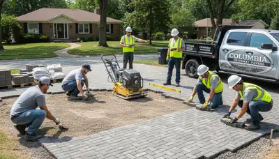 Crew installing driveway pavers in Columbia, MO with precise leveling and alignment for durable landscaping results